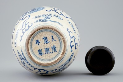 A Chinese blue and white soft paste jar with wooden cover, 19th C.